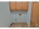 Laundry room with cabinetry, tile floors and hookups at 7869 Cherry Point Dr, Denver, NC 28037