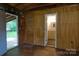 Rustic living room leads to bathroom, showcasing potential for renovation and customization at 7869 Cherry Point Dr, Denver, NC 28037