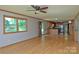 Bright living room with hardwood floors leads into open kitchen with natural light at 7869 Cherry Point Dr, Denver, NC 28037