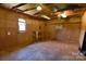 Spacious living room with natural wood walls, perfect for hobbies or converting to your vision at 7869 Cherry Point Dr, Denver, NC 28037