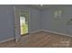 Light blue room features new floors and an entrance to the fenced backyard at 7869 Cherry Point Dr, Denver, NC 28037