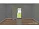 Light blue room offers new floors and an entrance to the backyard at 7869 Cherry Point Dr, Denver, NC 28037