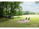 The backyard features a cleared area, Adirondack chairs, and a fire pit at 8340 Brief Rd, Mint Hill, NC 28227