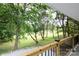 Wood railing lines this porch which provides views of the serene backyard at 8340 Brief Rd, Mint Hill, NC 28227