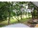 Manicured backyard with wooded backdrop is accessible from the porch at 8340 Brief Rd, Mint Hill, NC 28227