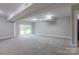 Spacious finished basement with modern lighting fixtures, plush carpeting, and walk-out access at 8340 Brief Rd, Mint Hill, NC 28227