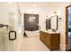 Beautiful bathroom with a soaking tub, wooden vanity and modern fixtures at 8340 Brief Rd, Mint Hill, NC 28227