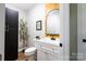 Modern half bathroom features a stylish mirror, sleek fixtures, and ample storage at 8340 Brief Rd, Mint Hill, NC 28227