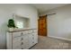 Bedroom with wood dresser and a sliding barn door at 8340 Brief Rd, Mint Hill, NC 28227