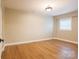 This bedroom offers a large window, neutral walls, and hardwood floors at 8340 Brief Rd, Mint Hill, NC 28227