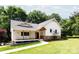Inviting exterior showcasing a charming home with a covered porch and beautifully landscaped lawn at 8340 Brief Rd, Mint Hill, NC 28227
