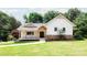 Inviting exterior showcasing a charming home with a covered porch and beautifully landscaped lawn at 8340 Brief Rd, Mint Hill, NC 28227