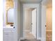 Hallway view featuring a vanity with wood accent wall and a doorway leading to another room at 8340 Brief Rd, Mint Hill, NC 28227