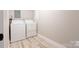 Bright laundry room with modern machines and durable flooring for easy maintenance at 8340 Brief Rd, Mint Hill, NC 28227