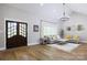 Bright living room with soaring ceilings, stylish chandelier, and lots of natural light at 8340 Brief Rd, Mint Hill, NC 28227