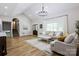 Open-concept living space featuring wood floors and seamless flow from the living room to the kitchen at 8340 Brief Rd, Mint Hill, NC 28227