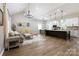 Open-concept living space featuring wood floors and seamless flow from the living room to the kitchen at 8340 Brief Rd, Mint Hill, NC 28227
