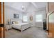Bright main bedroom with vaulted ceiling, chandelier, carpet and neutral walls at 8340 Brief Rd, Mint Hill, NC 28227