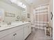 Bright bathroom with double vanity, neutral paint, and a shower/tub combo, creating an inviting space at 9405 Gladden Hill Ln, Pineville, NC 28134