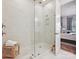 A walk-in shower with white tile and glass door, as well as a wood bench at 9405 Gladden Hill Ln, Pineville, NC 28134