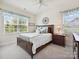 Bright bedroom featuring a large window, ceiling fan, comfortable furniture and relaxing, cozy space at 9405 Gladden Hill Ln, Pineville, NC 28134