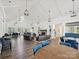 Spacious clubhouse area featuring hardwood floors, ample seating, fireplace, and elegant lighting at 9405 Gladden Hill Ln, Pineville, NC 28134