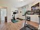 Well-equipped home gym features a treadmill, exercise bike, and weights for a complete workout at 9405 Gladden Hill Ln, Pineville, NC 28134