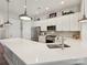 Modern kitchen features white cabinets, stainless steel appliances, a large island with counter seating at 9405 Gladden Hill Ln, Pineville, NC 28134