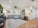 Spacious living room features a large gray sectional, ceiling fan, area rug, and natural light at 9405 Gladden Hill Ln, Pineville, NC 28134