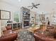 Cozy living room featuring a stone fireplace, wood floors, and an open layout to the dining area at 9405 Gladden Hill Ln, Pineville, NC 28134