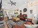 Bright, open-concept living room with hardwood floors, a stone fireplace, and access to the modern kitchen at 9405 Gladden Hill Ln, Pineville, NC 28134