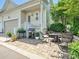 Outdoor patio with a seating area, grill, and lush greenery perfect for entertaining and relaxing at 9405 Gladden Hill Ln, Pineville, NC 28134