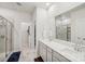 Modern bathroom featuring double sinks, a large mirror, and walk-in shower at 9525 Festival Way, Charlotte, NC 28215