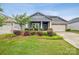 Charming single-story home with a well-manicured lawn and flower beds, showcasing lovely curb appeal at 9525 Festival Way, Charlotte, NC 28215