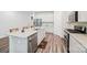 Well-equipped kitchen featuring white cabinets, a granite island, and stainless steel appliances at 9525 Festival Way, Charlotte, NC 28215