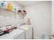 The laundry room has a washing machine and dryer with storage shelves at 9525 Festival Way, Charlotte, NC 28215