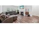 Cozy living room with a fireplace, comfortable seating, and lots of natural light from the windows at 9525 Festival Way, Charlotte, NC 28215
