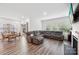 Open-concept living area featuring wood flooring, comfortable seating, and a dining area with lots of light at 9525 Festival Way, Charlotte, NC 28215