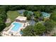 Aerial view of community amenities including a pool, tennis courts, and recreation areas surrounded by trees at 9901 Pallisers Ter, Charlotte, NC 28210