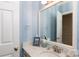 Charming half-bathroom with patterned walls, a decorative mirror, and a granite countertop at 9901 Pallisers Ter, Charlotte, NC 28210