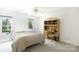 Cozy bedroom with soft carpeting, dual windows, and a built-in desk area at 9901 Pallisers Ter, Charlotte, NC 28210