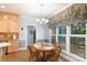 Cozy breakfast nook featuring a round table, four chairs, and views of the lovely backyard at 9901 Pallisers Ter, Charlotte, NC 28210