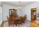 Formal dining room with hardwood floors, chandelier, and a china cabinet at 9901 Pallisers Ter, Charlotte, NC 28210