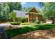 Charming brick home with well-manicured front lawn, mature trees and beautiful landscaping at 9901 Pallisers Ter, Charlotte, NC 28210