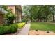 Beautiful brick home featuring lush landscaping and a charming walkway at 9901 Pallisers Ter, Charlotte, NC 28210