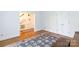 Open hallway featuring hardwood floors, a staircase, and access to the home's interior at 9901 Pallisers Ter, Charlotte, NC 28210