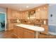 Bright kitchen with granite countertops, wood cabinets, and tiled backsplash at 9901 Pallisers Ter, Charlotte, NC 28210