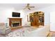Inviting living room features a fireplace, built-in bookshelves, and hardwood floors at 9901 Pallisers Ter, Charlotte, NC 28210