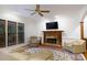 Bright living room features a fireplace, hardwood floors, and large windows at 9901 Pallisers Ter, Charlotte, NC 28210
