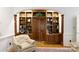 Stylish living room featuring custom built-in shelving and hardwood floors at 9901 Pallisers Ter, Charlotte, NC 28210